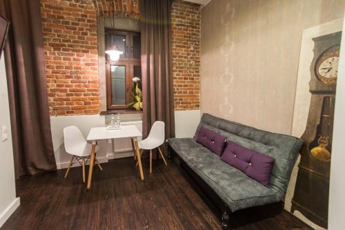 a living room with a couch and a table at Good Time Aparthotel in Łódź
