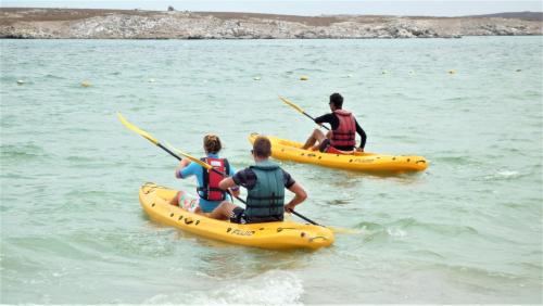 a group of people in kayaks in the water at Windtown Lagoon Hotel in Langebaan