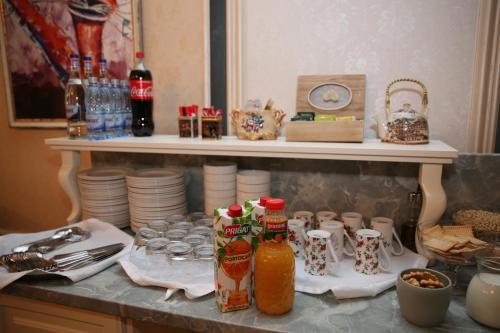a counter top with a shelf with food and drinks at Valentino Rooms in Focşani