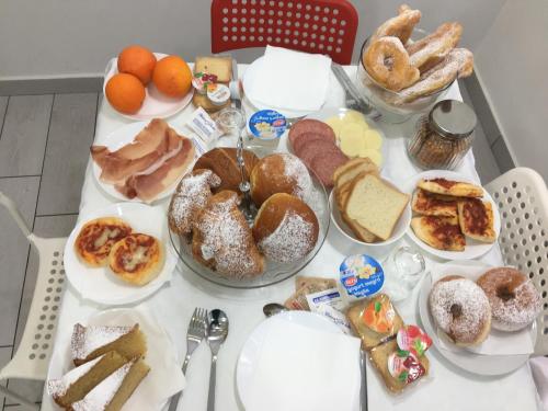 a table topped with lots of different types of pastries at Maison De luxe in Pompei