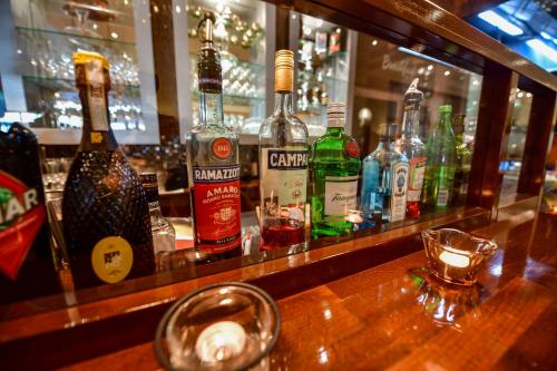 a bar with many bottles of alcohol on a counter at STADT HOTEL Iserlohn in Iserlohn