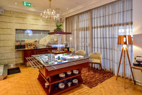a lobby with a display case with food on it at STADT HOTEL Iserlohn in Iserlohn