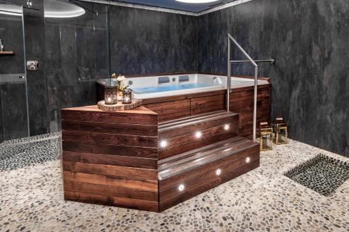 a bathroom with a bath tub in a room at Fiocco di Neve Relais & SPA in Limone Piemonte