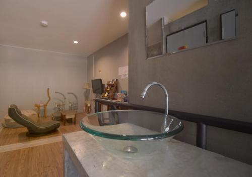 a bathroom with a glass bowl sink on a counter at OK CHIC PHUKET HOSTEL in Phuket