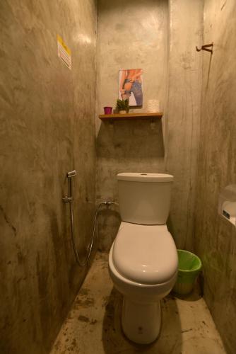 a bathroom with a white toilet in a dirty room at OK CHIC PHUKET HOSTEL in Phuket Town