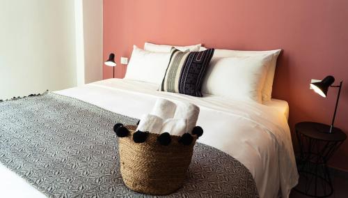 a bedroom with a bed with a basket on it at Zefiro Suites in Palermo