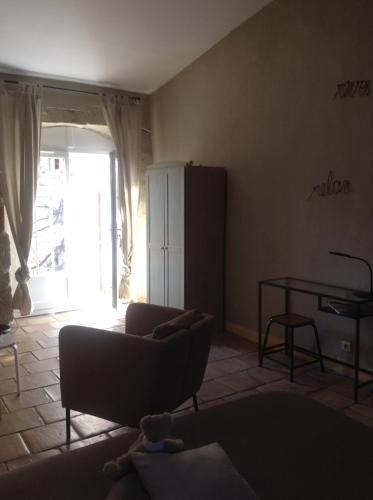 a living room with a couch and a table at La demeure in Eyguières