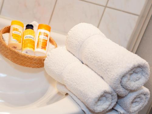 a basket of towels on a toilet in a bathroom at Haus Koch-Lechner in Marquartstein