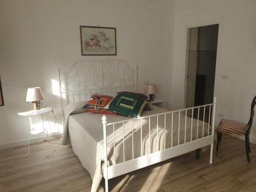 a bedroom with a white bed and a chair at Al 17 in Sturno
