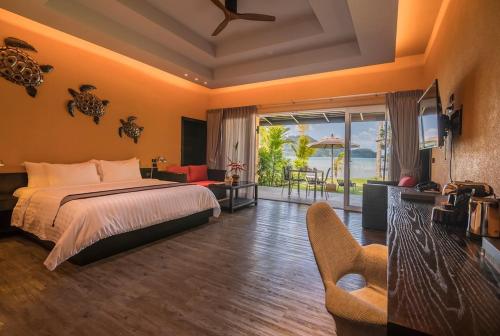 a bedroom with a bed and a view of the ocean at Peninsula Beach Resort in Ko Chang