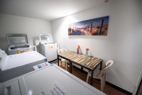 a small kitchen with a table and a refrigerator at 48 Metro Hotel in Bangkok