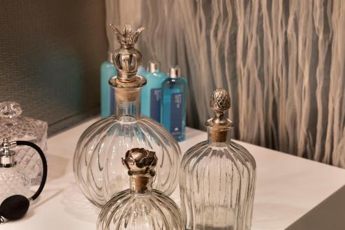 two glass bottles sitting on top of a table at Royal Beach Hotel Tel Aviv by Isrotel Exclusive in Tel Aviv