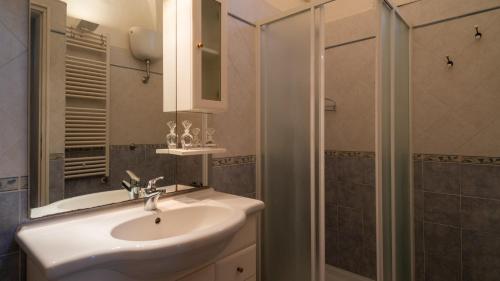 a bathroom with a white sink and a shower at Italianway - Casa del Barone in Lecce