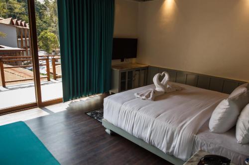 a bedroom with a bed with a towel on it at Symphony Samudra Beachside Jungle Resort And Spa in Port Blair