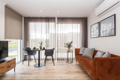 a living room with a couch and a table at Fields of Ellis in Middelkerke