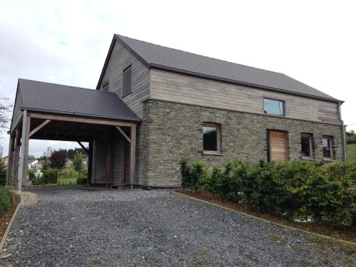 a large brick house with a garage at Vakantiewoning mogimont in Mogimont