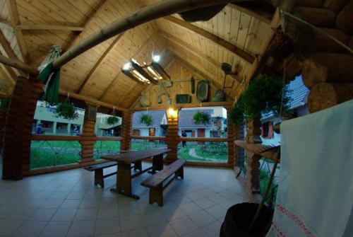 a wooden pavilion with benches and a table in it at Hotel Mirage in Sudovaya Vishnya