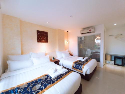 a hotel room with two beds and a fireplace at BLUE OCEAN BOUTIQUE HOTEL - Boracay Island in Boracay