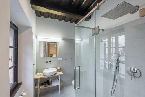 a bathroom with a glass shower with a sink at Fancy apartments by Prague Castle in Prague