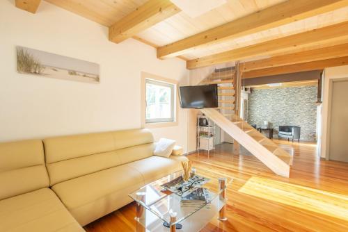 a living room with a couch and a tv at Holiday Home Casa Salina in Sečovlje