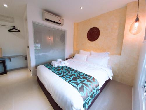 a bedroom with a large bed in a room at BLUE OCEAN BOUTIQUE HOTEL - Boracay Island in Boracay
