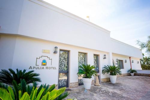 a building with plants in front of it at Città Bianca Country Resort in Ostuni