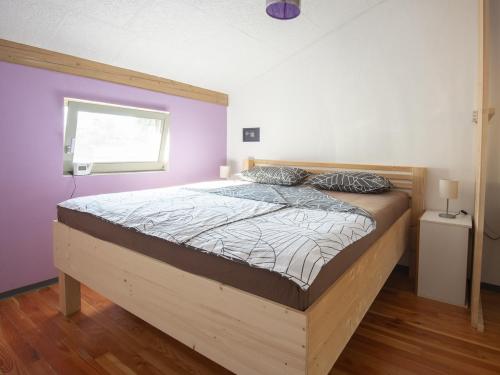 a bedroom with a large bed with a wooden frame at Holiday Home Casa Salina in Sečovlje