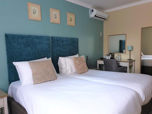 a large white bed in a hotel room at The Merchant's House, BW Signature Collection in Salisbury