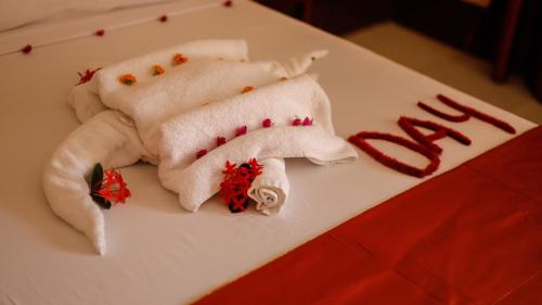 two towels with christmas decorations on a table at Amaan Beach Bungalows in Nungwi
