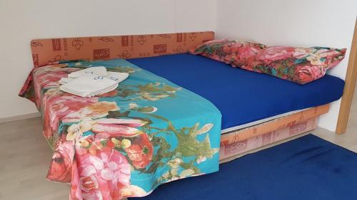 a bedroom with a twin bed with a blue bedspread at Apartments Angie in Biograd na Moru