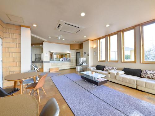 een woonkamer met een bank en een tafel bij Hotel S-PAL in Hakodate