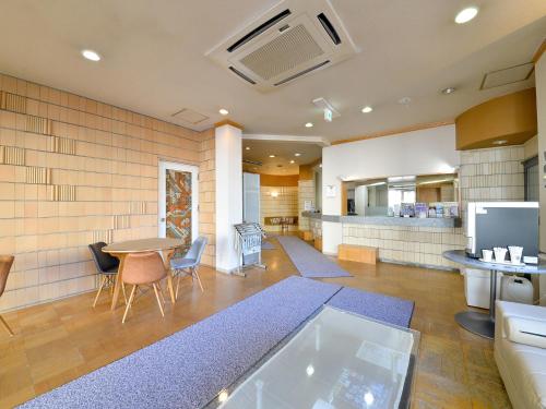 a large kitchen with a table and a dining room at Hotel S-PAL in Hakodate
