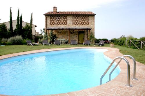 a swimming pool in front of a house at Tenuta Sant'Ilario in Gambassi Terme