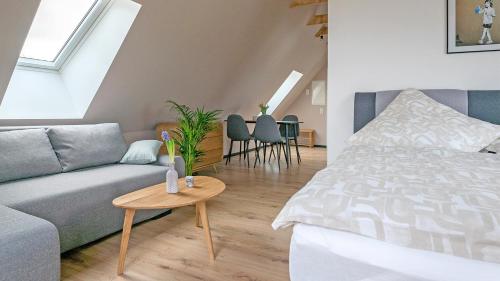 a living room with a couch and a table at Ferienwohnungen Harzblick in Bad Harzburg