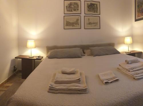a bedroom with a white bed with towels on it at B&B Jacopino in Florence