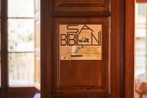 a sign on a door with a sign on it at Hostel Sóller in Sóller