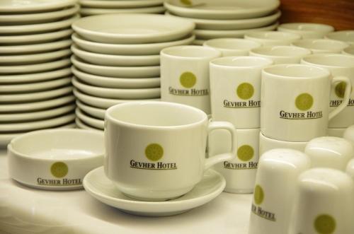 a group of cups and plates on a table at Gevher Hotel in Kayseri
