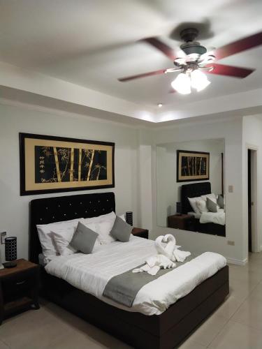 a bedroom with a bed with a ceiling fan at Bourbon St Apts Condo 16 in Angeles