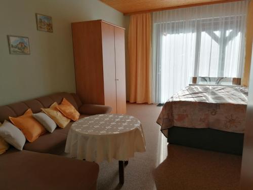 a living room with a couch and a bed at Ferienwohnung Fröhlich in Bad Suderode