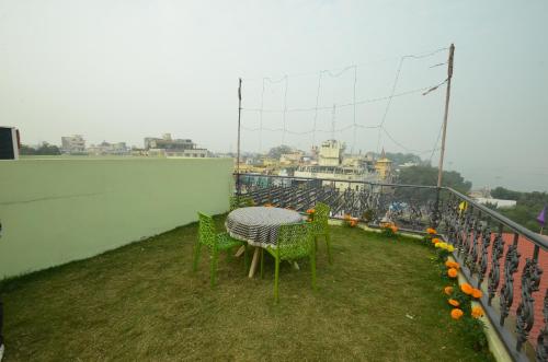 a table and chairs on top of a balcony at Hotel Temple On Ganges in Varanasi
