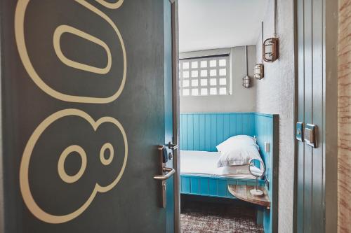 a door leading to a small bed in a room at Garrison Cells in Fort William