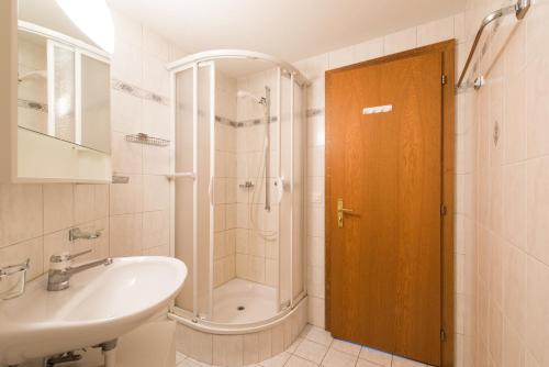 a bathroom with a shower and a sink and a toilet at Haus Evita in Saas-Grund