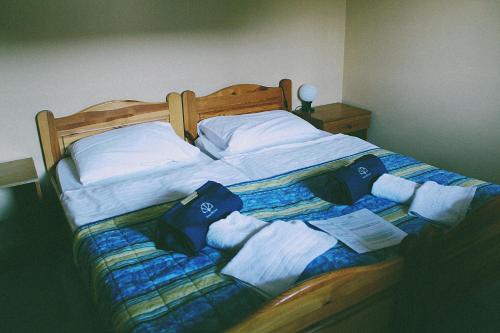 a bed with white pillows and towels on it at Terme Olimia - Apartment Village Lipa in Podčetrtek