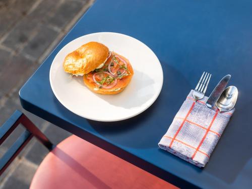 a white plate with a sandwich on a blue table at The Standard London in London