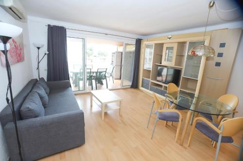 a living room with a couch and a glass table at DIFFERENTFLATS Santa Rosa in Salou