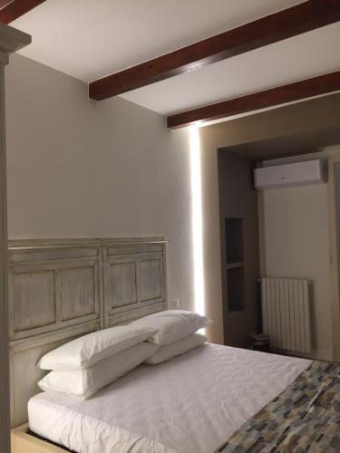 a bedroom with a bed with three pillows on it at Apulia 35 in Bari