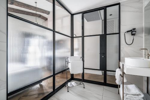 a bathroom with a sink and a mirror at Zamarin Hotel & Spa in Zikhron Ya‘aqov