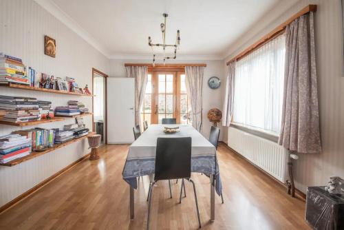 a dining room with a table and chairs in a room at Rustic room 15 mins from Brussels in Halle