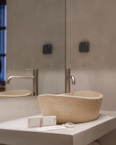 a bathroom with two sinks and two mirrors at Aldia Suites Arachova in Arachova