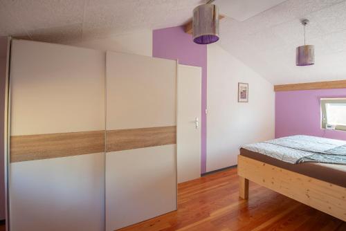 a bedroom with a bed and a large closet at Holiday Home Casa Salina in Sečovlje